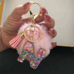 Pink fur pompom keychain with resin letter W pendant and colorful heart sequins