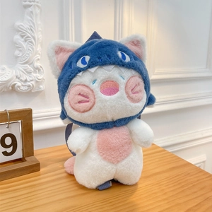Cute cartoon plush cat backpack with blue shark hoodie on a warm wooden background