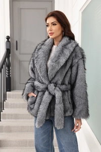 Detailed texture of grey faux fur coat featuring a waist belt and long sleeves for warmth