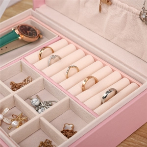 Detail view of pink jewelry box with ivory velvet lining and ring storage sections