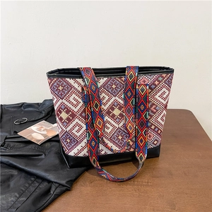 Ethnic style large tote bag with colorful geometric patterns and black leather trim