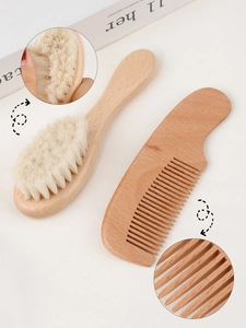 Close-up of soft wool bristles and smooth wooden comb for baby grooming set