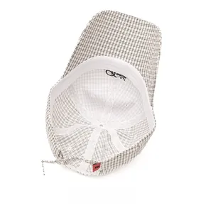 Detail view of the black and white plaid baseball cap interior with red label