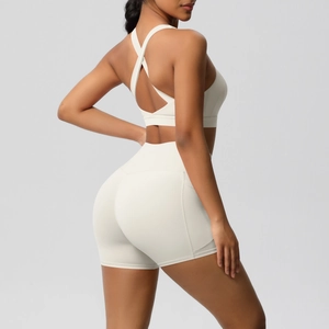 Detail of cross-back sports bra and high-waisted shorts in cream brushed fabric