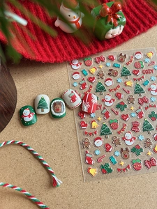 Close-up of Christmas nail art stickers with embossed trees and elk on kraft background