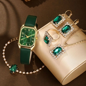 Detailed set of gold quartz watch with green gems, necklace, bracelet and earrings