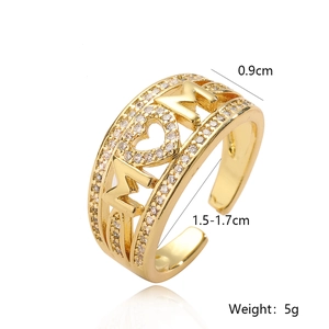 Detailed view of gold plated MOM letter ring with white zircons and heart hollow design