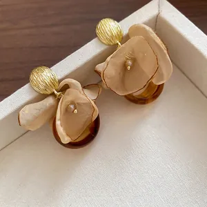 Elegant floral drop earrings with organza petals and resin rings in a luxury jewelry box