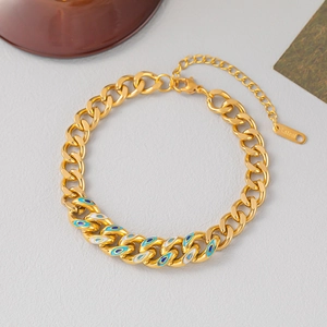 Bracelet cubain en acier titane doré avec détails en émail œil bleu et fermoir mousqueton