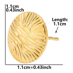 Macro detail of 1.1cm gold circular stainless steel stud earring with sunburst texture