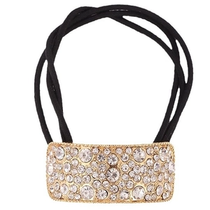 Elastic black hair tie with gold curved metal buckle featuring sparkling rhinestones