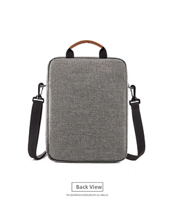 Rear view of a grey oxford fabric laptop briefcase featuring a brown leather handle