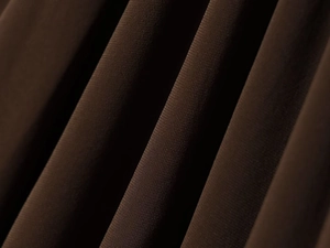Macro detail of dark brown woven fabric showing fine texture and draped pleats