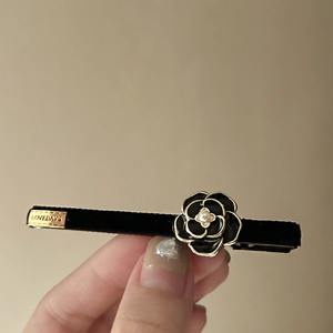 French vintage camellia hair clip with black velvet, gold finish, and faux pearl accents
