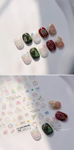 Macro view of 3D embossed Christmas nail stickers with Santa and snowflake motifs