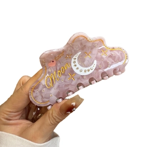 Pink marble acetate hair claw clip with celestial moon and star pattern for women