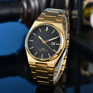 Detailed close-up of gold stainless steel watch with black checkered dial and date window