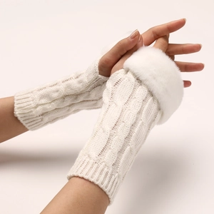 Detailed knit texture of ivory cable-knit fingerless gloves with plush faux fur trim