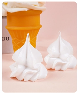 Close-up of white spiral cream dollhouse miniatures on a bright pink background