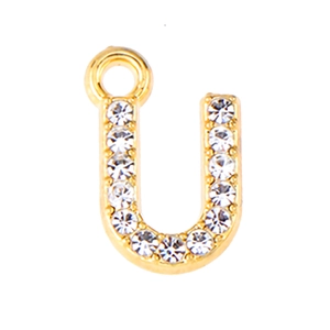 Macro shot of gold alloy letter U pendant with sparkling rhinestones for DIY jewelry