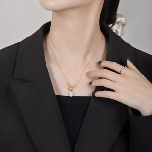 S925 sterling silver gold necklace with white teardrop pearl pendant on a model