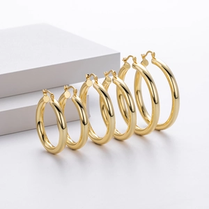 Detailed comparison of three sizes of gold-plated sterling silver hoop earrings on white blocks