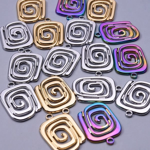 Macro detail of square spiral 304 stainless steel pendants in gold, silver, and rainbow colors