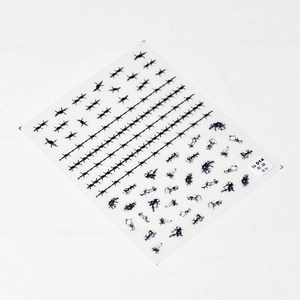 Detail view of thin flexible nail stickers featuring black thorn and wire designs
