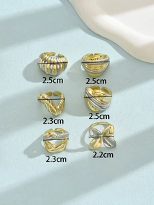 Set of six chunky mixed gold and silver rings with butterfly and wavy texture designs