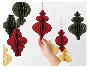 Detail of paper honeycomb ball decorations in red and green for Christmas party