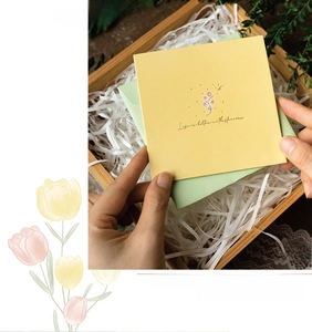 Close-up of 3D floral tulip greeting card and green envelope in a wooden gift box