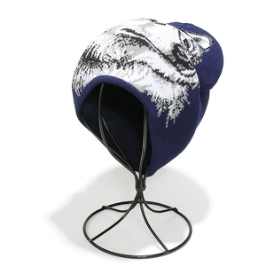 Close-up of navy blue knit beanie featuring realistic black and white wolf head print