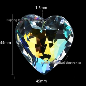Macro detail of 45mm heart-shaped faceted crystal pendant with rainbow light reflection