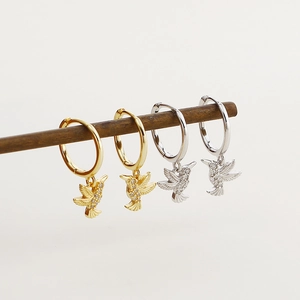 Detail showing gold and silver hummingbird hoop earrings with sparkling cubic zirconia stones