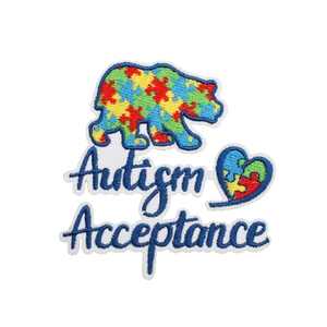 Embroidered autism acceptance bear and heart patches with colorful puzzle pattern