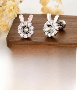 Detail of bunny ear titanium steel studs with 0.8x6mm screw bars and zircon inlay