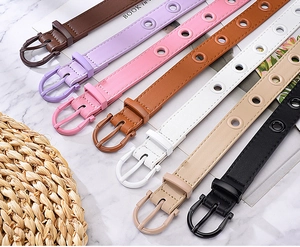 Flat lay of colorful candy-colored faux leather belts with hollow metal eyelets