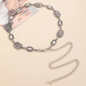 Detail of vintage silver waist chain featuring bohemian seashell and heart charms