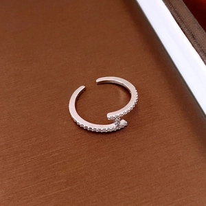Makroaufnahme des silberfarbenen T-förmigen offenen Rings mit Zirkonia-Mikropavé-Besatz