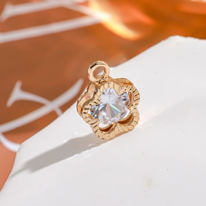 Macro shot of a 14K gold plated flower pendant with a sparkling central cubic zirconia
