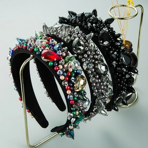 Detailed display of handcrafted velvet headbands with intricate rhinestones and pearls