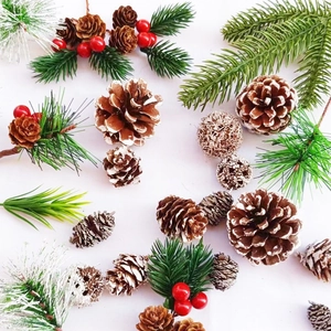 Christmas pine cones with artificial pine needles and red berries for festive decoration