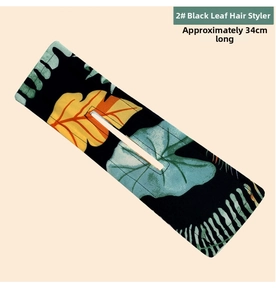 Black deft bun with yellow and cyan tropical leaf print, approximately 34cm long