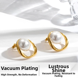 Macro shot of minimalist gold plated stainless steel earrings with white pearls