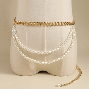 Elegant gold chain belt with layered white pearls and pearl pendant on a beige mannequin
