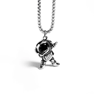 Detailed macro view of silver astronaut pendant on a square box chain necklace