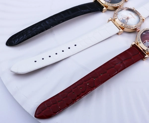 Detail of luxury ladies quartz watches with rhinestone bezel and crocodile leather straps