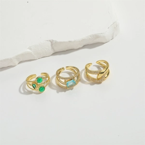 Set of 14K gold plated open rings with green and blue stones in a minimalist design