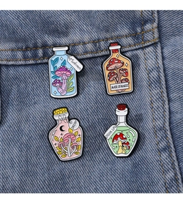 Set of four colorful mushroom drift bottle enamel pins pinned on dark blue denim fabric