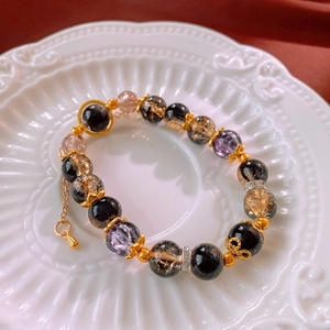 Detail of vintage beaded bracelet featuring quartz crystals and golden filigree spacers